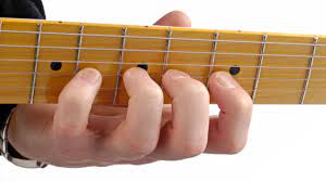 hand on guitar fretboard playing scale